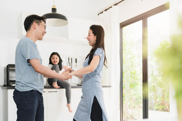 happiness asian family dad dancing with mom and daughter togehter home sweet home concept