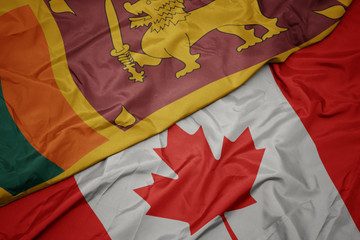 waving colorful flag of canada and national flag of sri lanka.