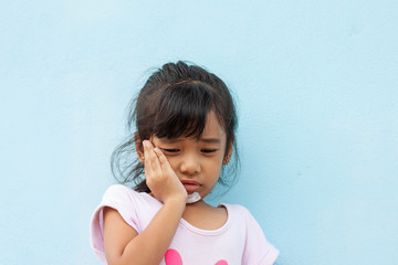 Little girl get pain from falling. And there is a wound around the chin which is covered with gauze.