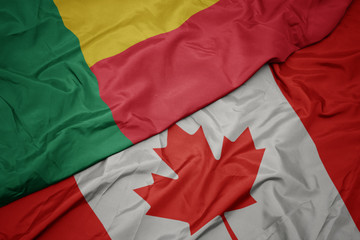 waving colorful flag of canada and national flag of benin.