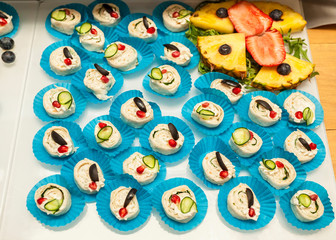 Tortilla wrap sliced into bites on blue cupcake liners