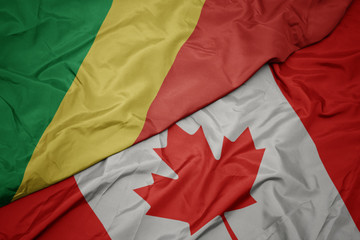 waving colorful flag of canada and national flag of republic of the congo.