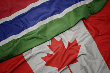 waving colorful flag of canada and national flag of gambia.