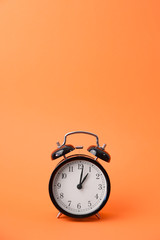 vintage alarm clock on a orange background