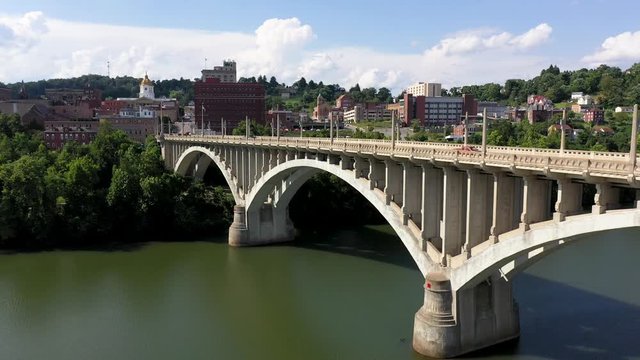 Aerial camera moving forward at angle showing Million Dollar Bridge and the city of Fairmont, WV on the Monongahela River.