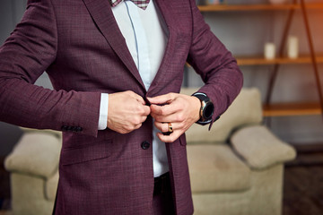 Businessman wears a jacket,male hands closeup,groom getting ready in the morning before wedding...