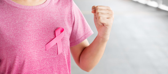 October Breast Cancer Awareness month, Woman in pink T- shirt with Pink Ribbon for supporting...