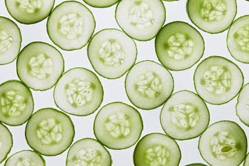 Fresh cucumber slices on a white background