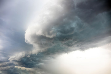 Fototapeta na wymiar big bright thundercloud in a gray stormy sky