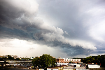 dramatic gray stormy sky with a big cloud over the city