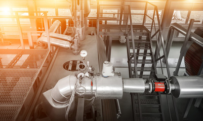 Control system for gas boiler. Boiler room with gas boilers and pipes for supplying gas and steam.  View from above with sun flares