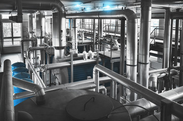 Modern industrial gas boiler room equiped for heating process.  Pipelines, valves.  View from...