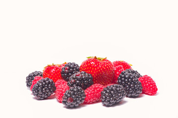 Fresh berries on the white background. Ripe Sweet strawberries, raspberries, blackberries