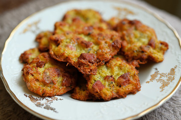 Potato pancakes with sausage on a ceramic plate.