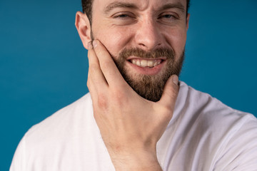 Handsome young man while having toothpain. Unhappy face. Harrd toothpain.