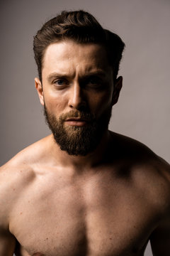 Sexy closeup portrait of handsome topless male model with beautiful eyes. Black and White.