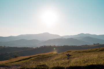 Big hills with sun over them.