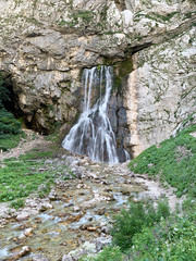 Gega, Abkhazia, August, 06.2019. Woman walking near Gega waterfall and river in Abkhazia