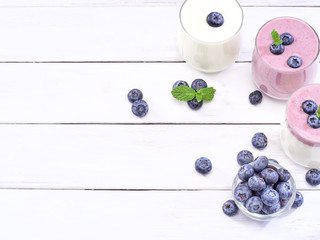 Naklejka na ściany i meble Blueberry yogurt and white yogurt on wooden table