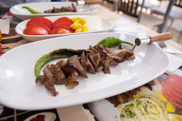 Beef meat kebab on the metal skewer.