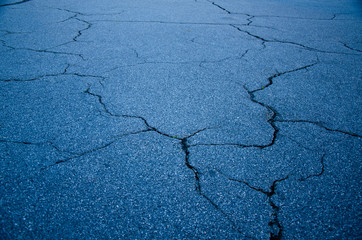 Cracked asphalt surface texture background