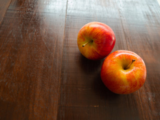 Two apple fruit, on a wooden background.