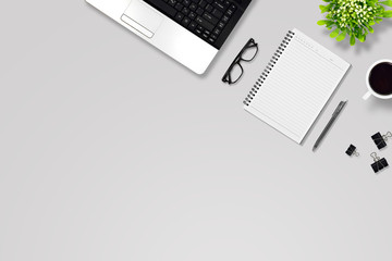 Office desk or education desk with laptop, Pen, Notebook, paper clip, glasses, Flower vase, coffee, supplies with copy space background, Top view/flat lay 