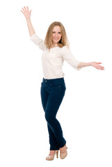 Portrait of a cheerful young woman in jeans with hands side isolated over white background