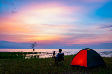 Lonely man camping near lake at Pak pra, Phatthalung, Thailand