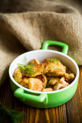 chicken fried in batter with dill on a plate