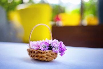 Fototapeta na wymiar Small flower bouquet in baskets on white table