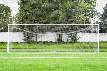 Fototapeta premium View of the football gate by the green grass field.