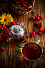 Obraz na płótnie Canvas hot tea from medicinal fruits of red ripe rosehip