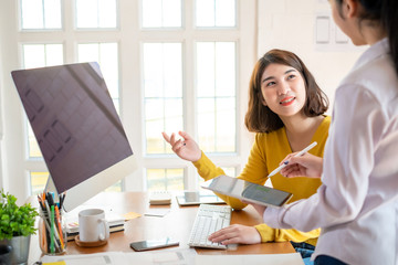 Two female designers drawing a website outline and website ux app development on mobile phone.