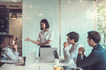 Group of young business people. A group of successful businessmen talking and working together at meeting.
