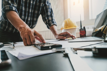 Architect with creativity for designing projects and drawing on blueprint on the office.