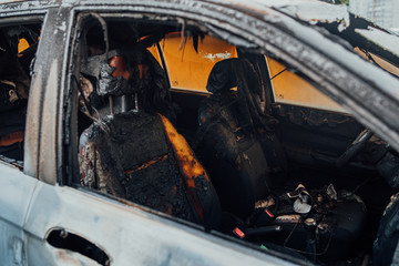 Vandalism or revenge, burnt car. The consequences of popular protest, burnt car, a crime. Car after fire. Auto trash
