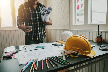 Architect with creativity for designing projects and drawing on blueprint on the office.