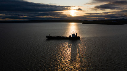 Fototapeta na wymiar The sea vessel against the background of a sunset.