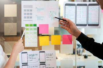 Designer team creative idea website designer Draw outline and develop applications on smartphone.