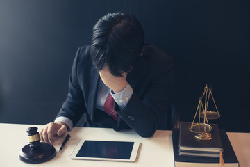 Lawyer is tired from working, sitting in a lawyer office.