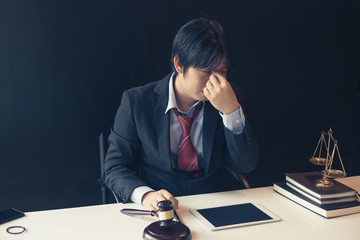 Lawyer is tired from working, sitting in a lawyer office.