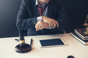 Lawyer man wrist pain sitting at office.