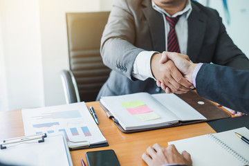 Businessman shaking hands agreement confirmed in the investment business.