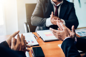Business success. Businessman clapping and congratulated during the meeting.