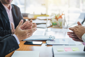 Business success. Businessman clapping and congratulated during the meeting.