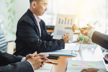 Business people meeting explaining the financial graph data and marketing plan.