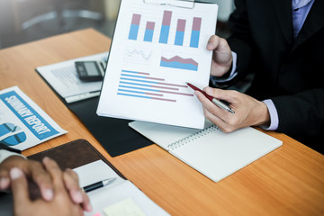 Business people meeting explaining the financial graph data and marketing plan.