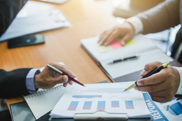 Business people meeting explaining the financial graph data and marketing plan.