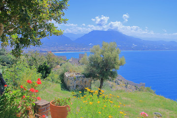 Seascape with a mountain range and an ancient fortress.